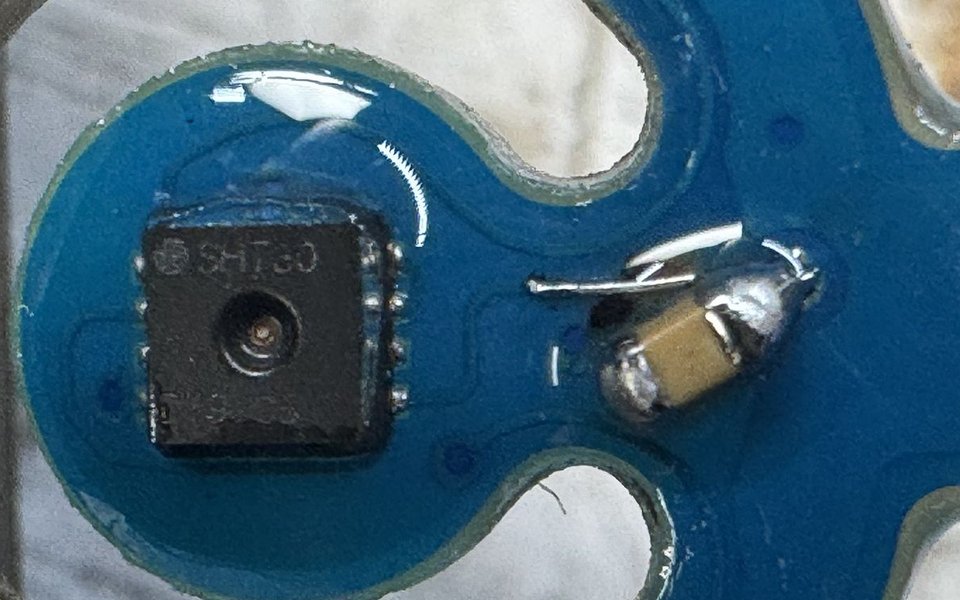 Blue sensor board with an SHT30 and a newly soldered capacitor